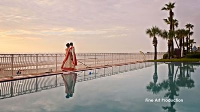 bride and groom walking near pool