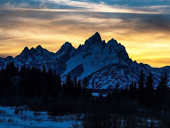 Sunset at the mountains covered with snow near Hotel Jackson