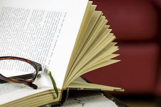 Close photo of a book with glasses