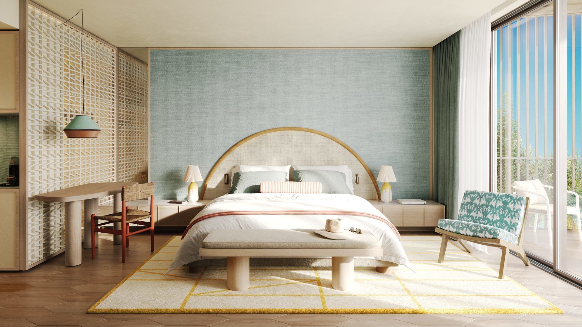 Bedroom with a large bed, colorful chairs, wooden floor, and sliding glass doors leading to a balcony.