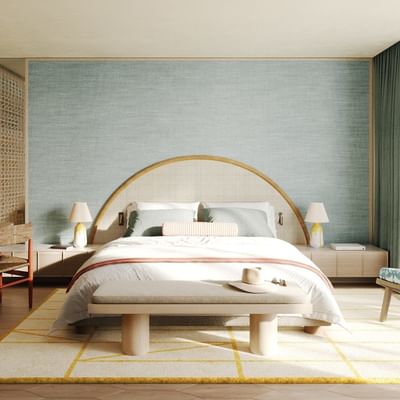 Bedroom with a large bed, colorful chairs, wooden floor, and sliding glass doors leading to a balcony.