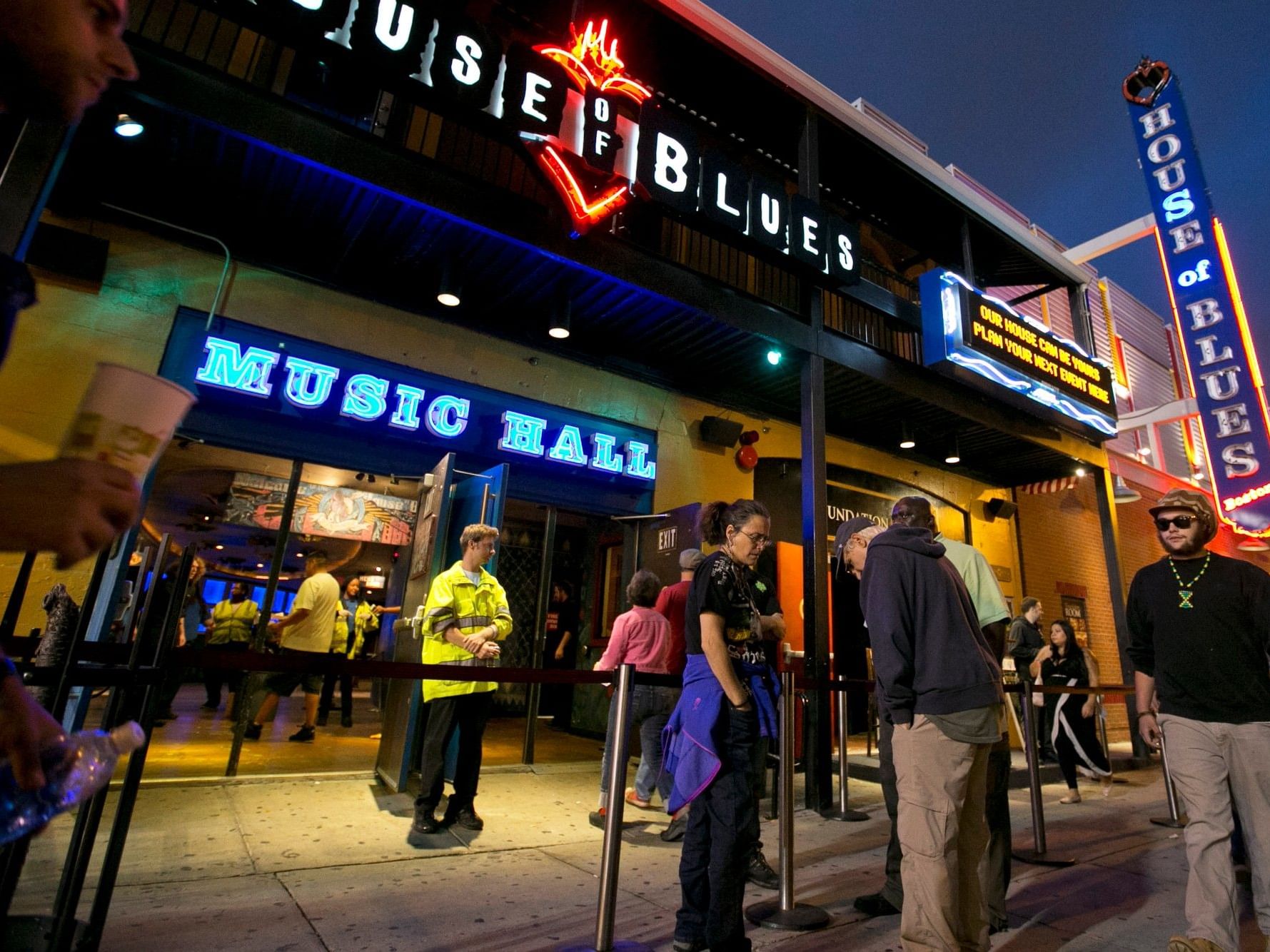 Exterior of the MGM Music Hall at Fenway at dusk with people milling about.