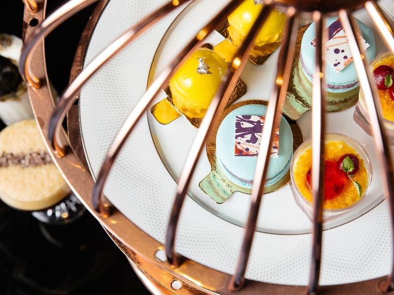 An assortment of colorful pastries on a white plate in TWR at Crown Towers Perth