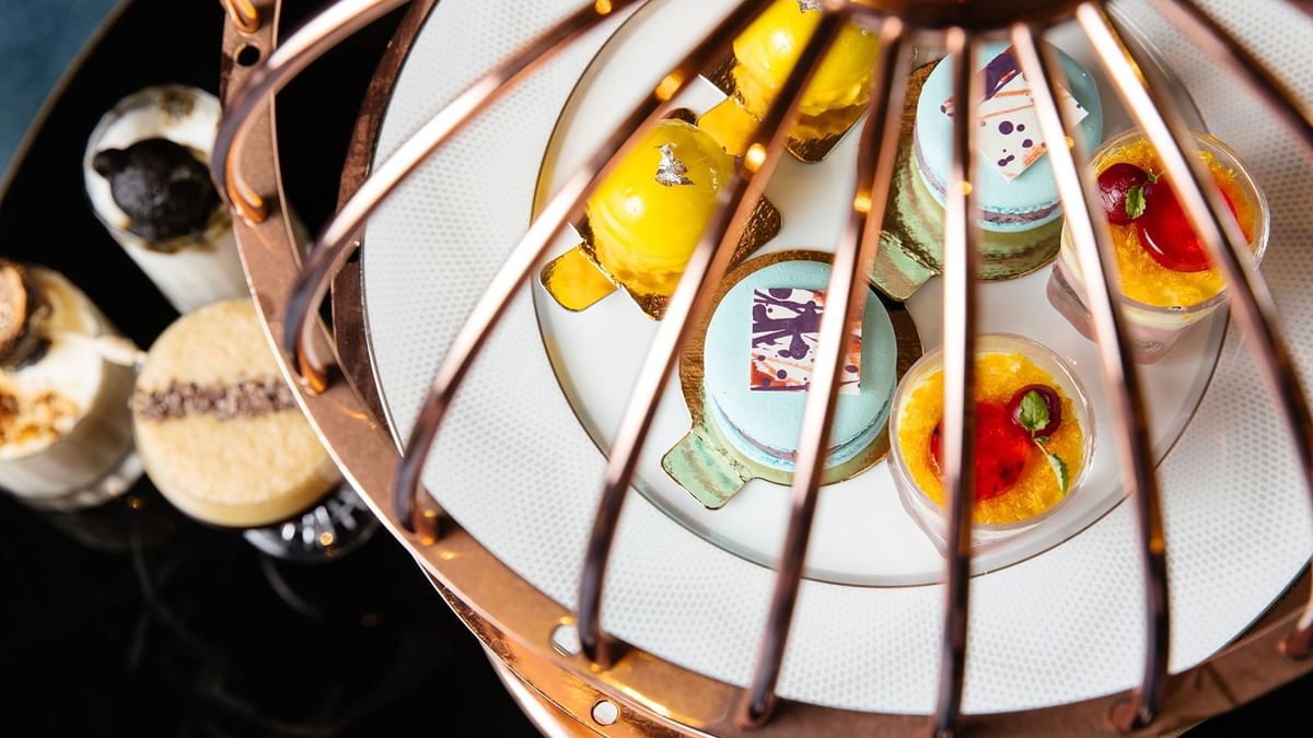 An assortment of colorful pastries on a white plate in TWR at Crown Towers Perth