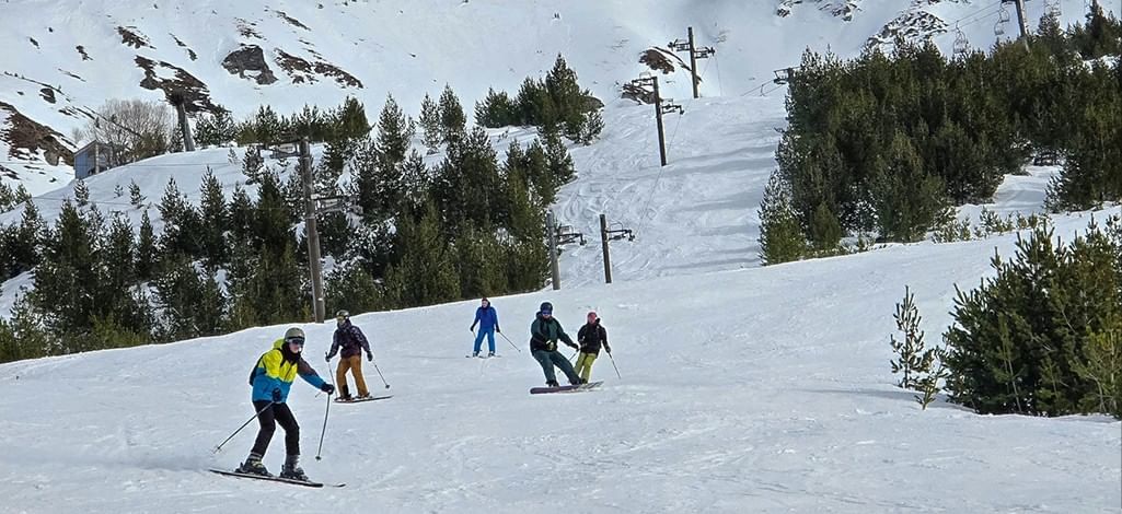 Skiers come down a small ski hill near Banff.