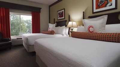 two queen beds and pillow with the letter C