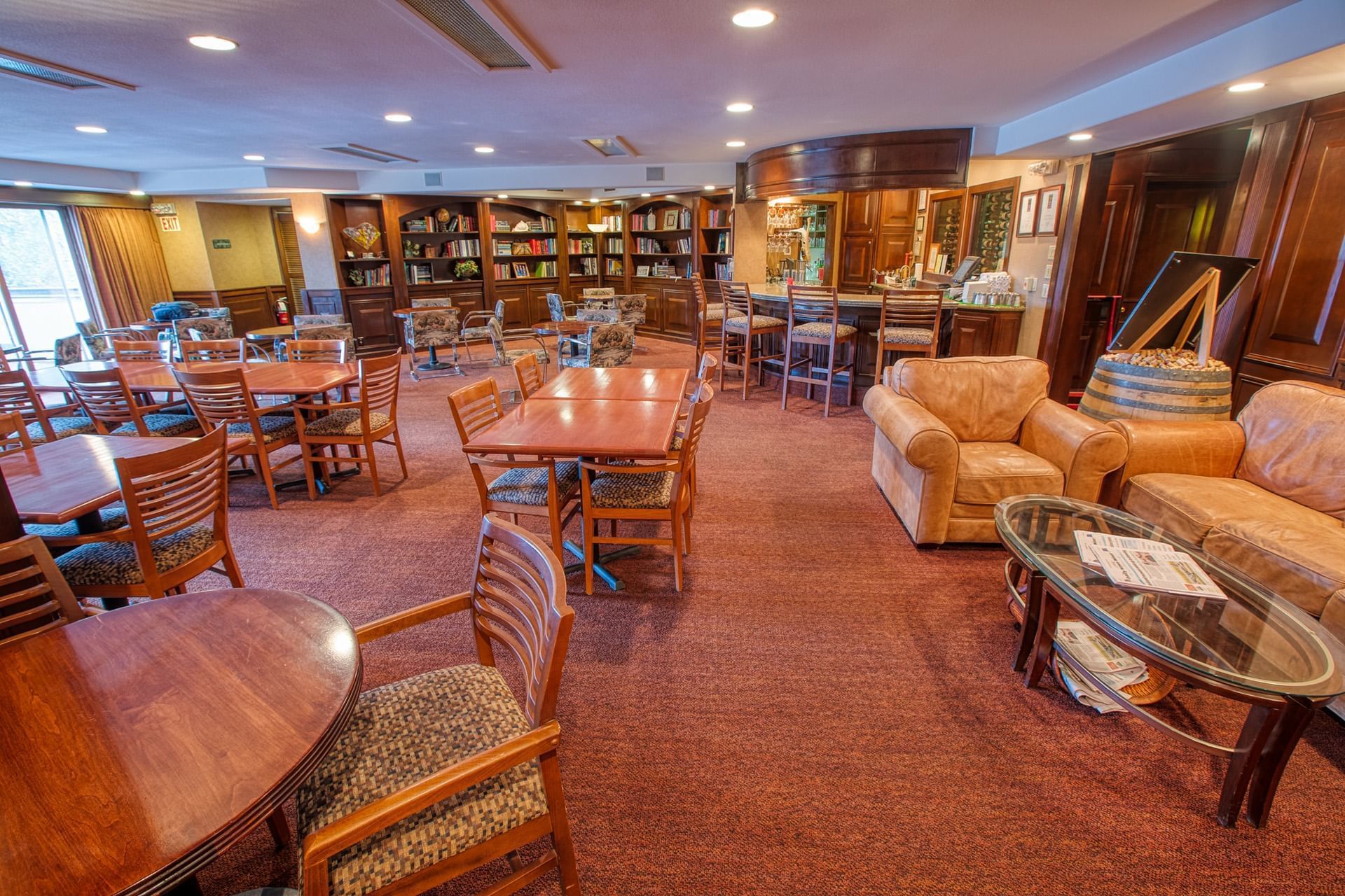 Dining area with tables chairs and sofa Sophie Station Suites