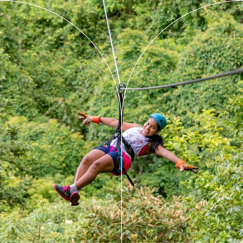 A lady ziplining through the forest near Punta Islita Hotel