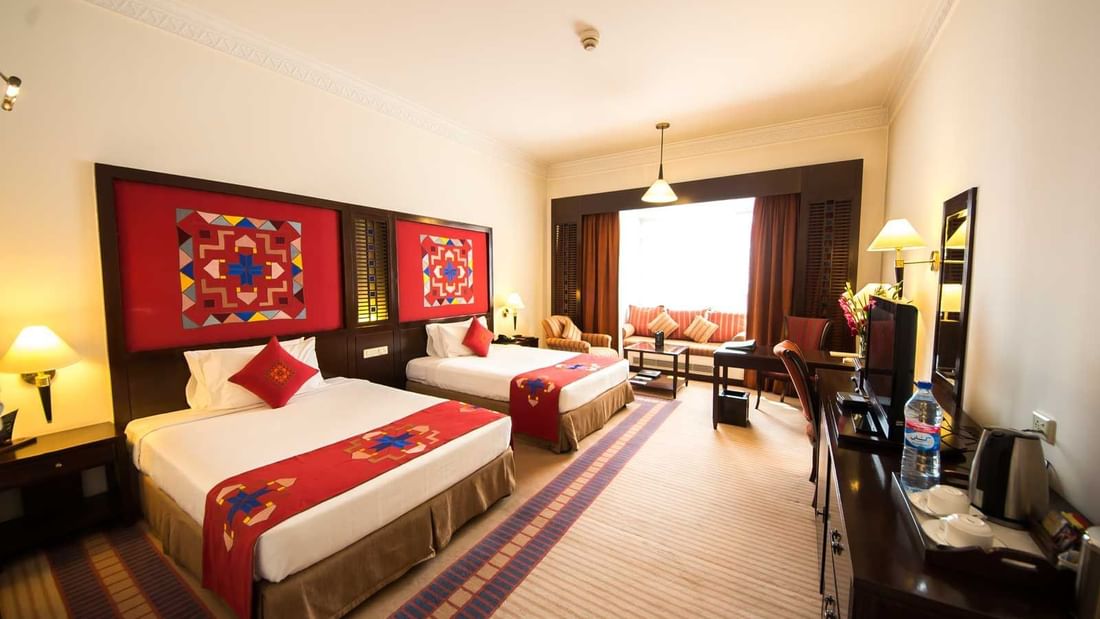 Interior of Deluxe Room with twin beds at Kabul Serena Hotel