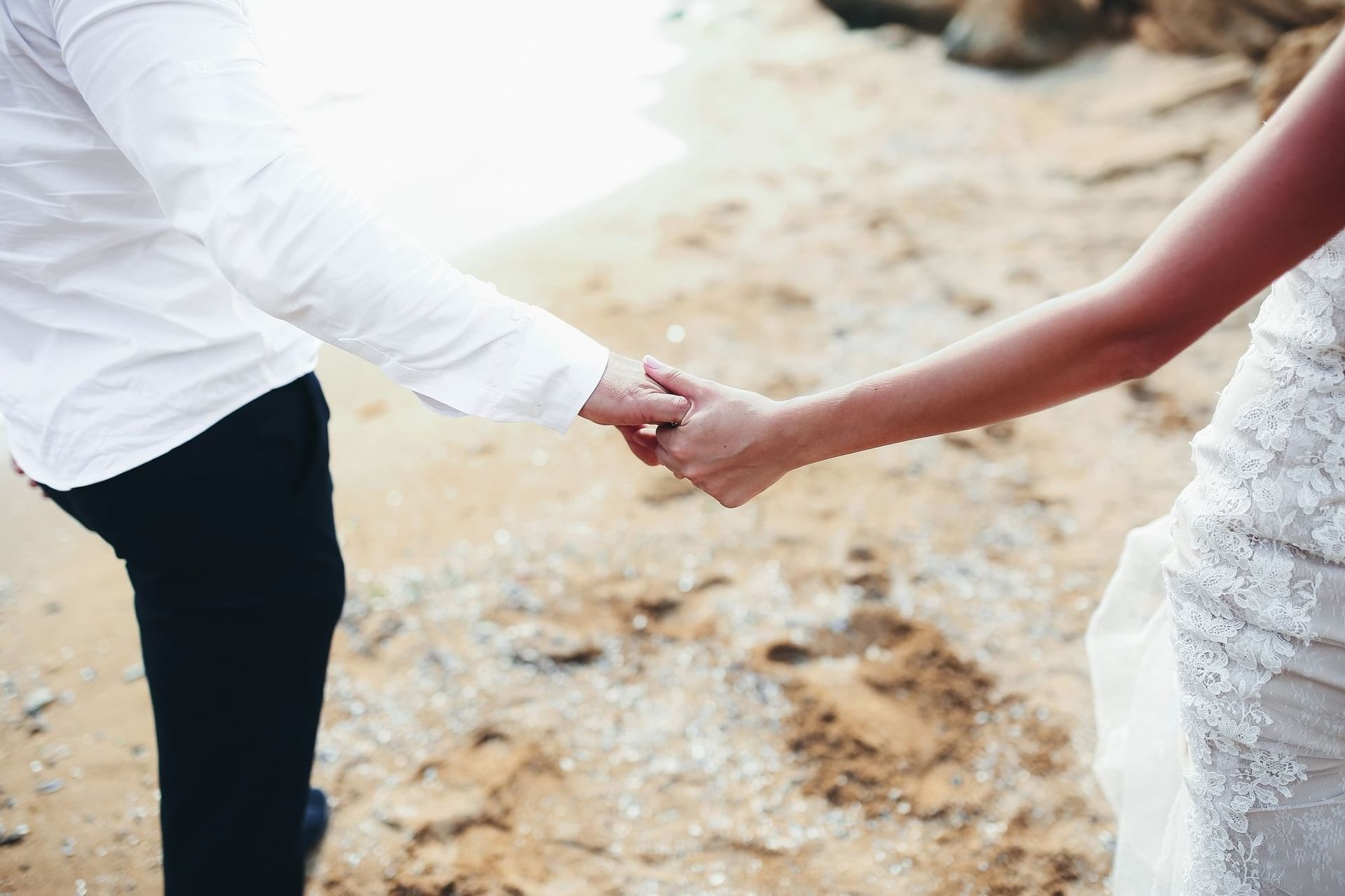 holding hands on beach