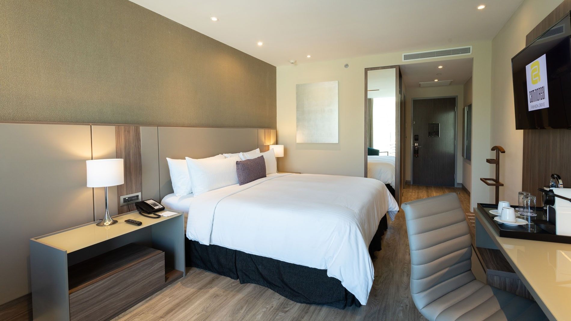 King Deluxe Superior with a king bed, bedside lamp, desk, & tall wall-mounted mirror at Camino Real Fashion Drive, Monterrey