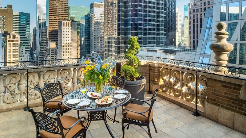 Dining table on a balcony in 54th Suite at Warwick New York