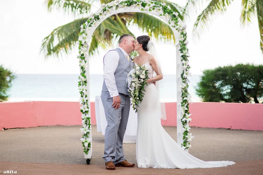 Wedded couple kissing at Southern Palms Beach Club