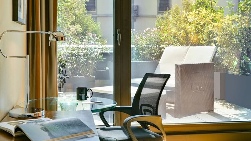 Work desk & balcony lounge in Classic Terrace Room at Warwick Geneva