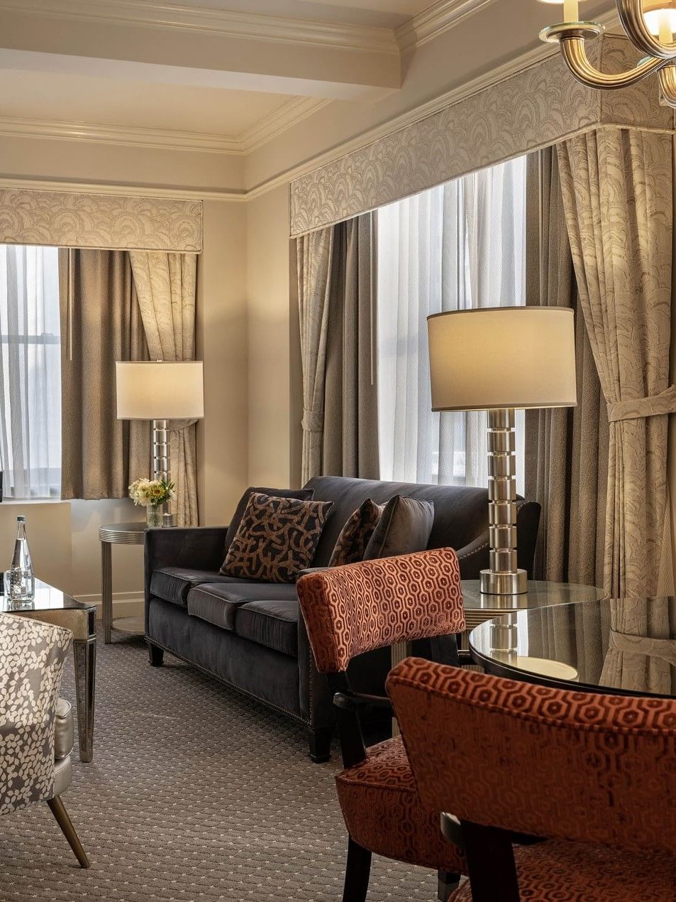 Accessible On the Avenue Suite living area with plush sofa near window at Warwick New York