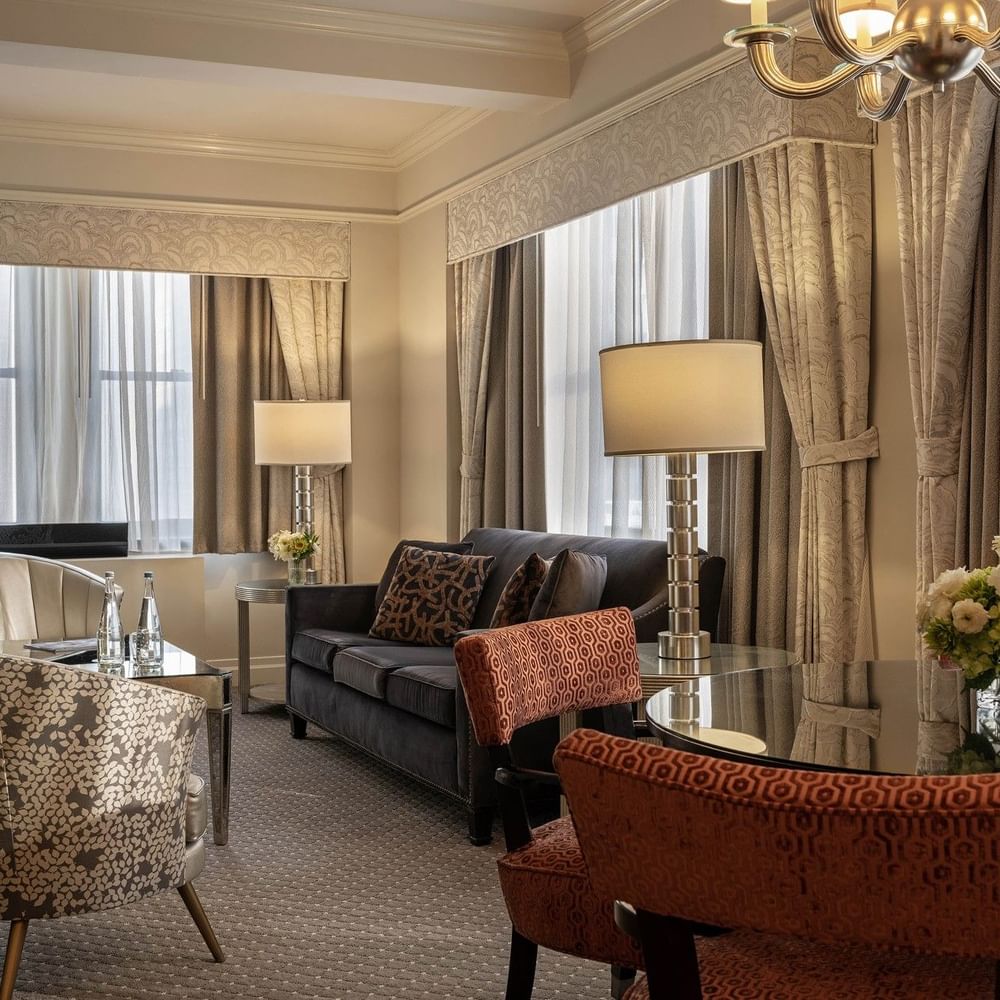 Accessible On the Avenue Suite living area with plush sofa near window at Warwick New York