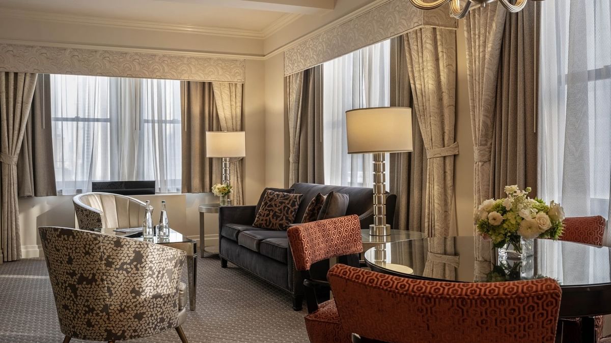 Accessible On the Avenue Suite living area with plush sofa near window at Warwick New York