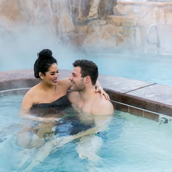Close up on a couple smiling in the hot tub at Stein Lodge