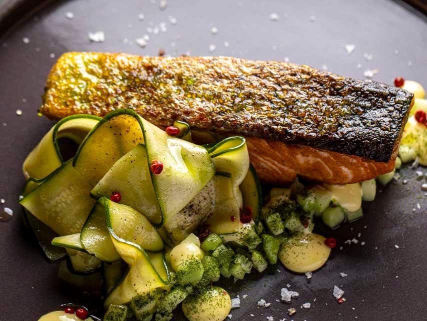 Close-up of a fish and vegetable dish served in EMME restaurant at Margutta 19