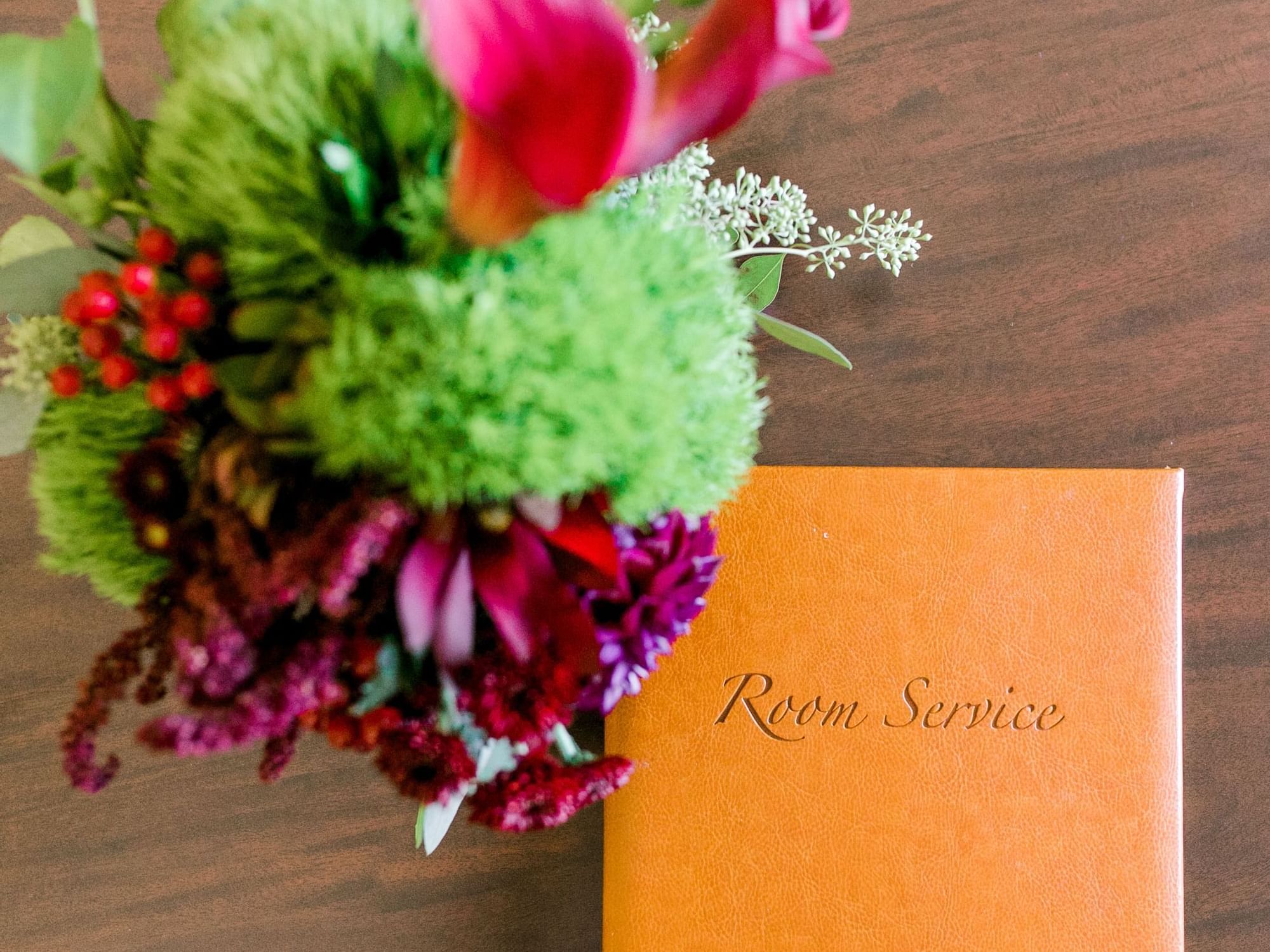 Room Service menu and flowers on table