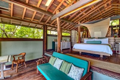 Ocean View Bungalows at Morgan’s Rock with plush bed, sofa, and garden views, perfect places to stay in Nicaragua