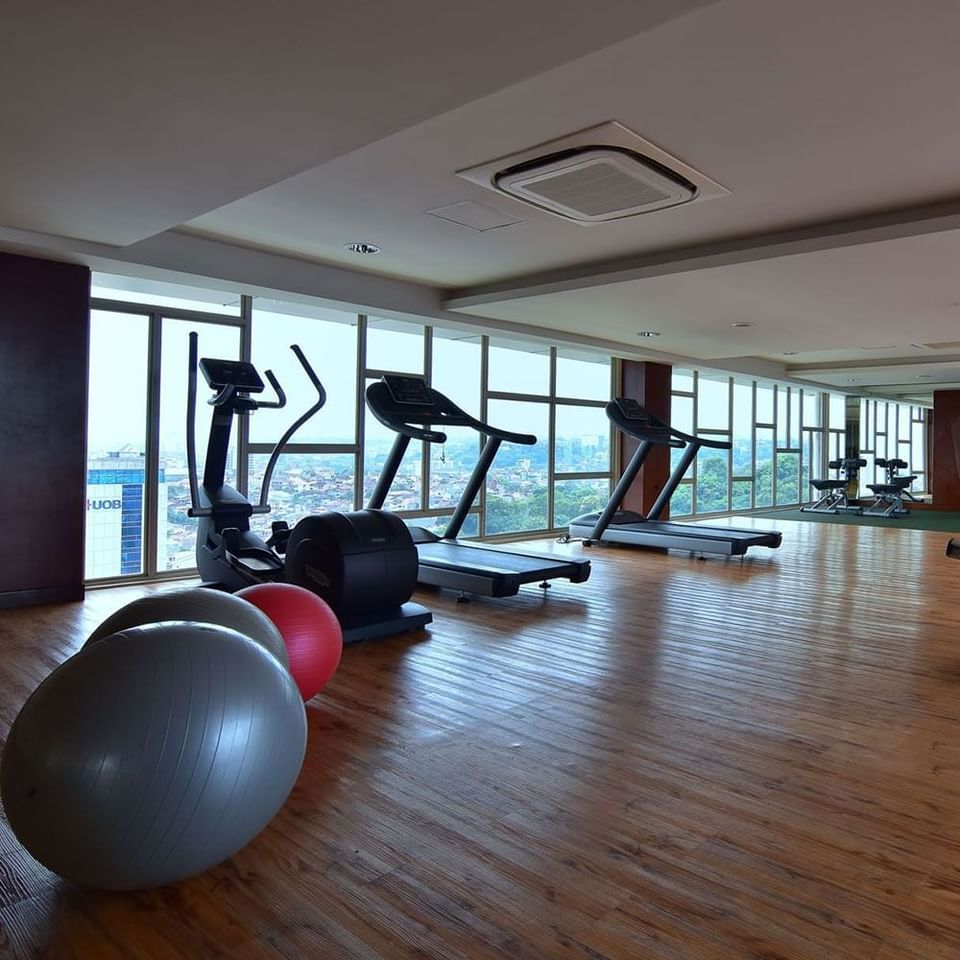 Exercise machines in the Gym with wooden floors at LK Pandanaran Hotel & Serviced Apartments