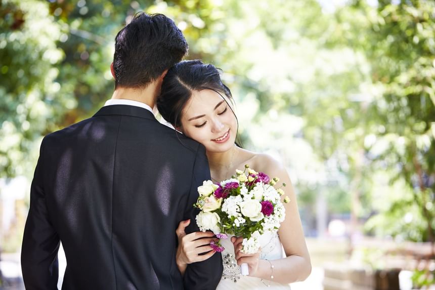 Wedding couple hugging each other at Momentus Hotel Alexandra