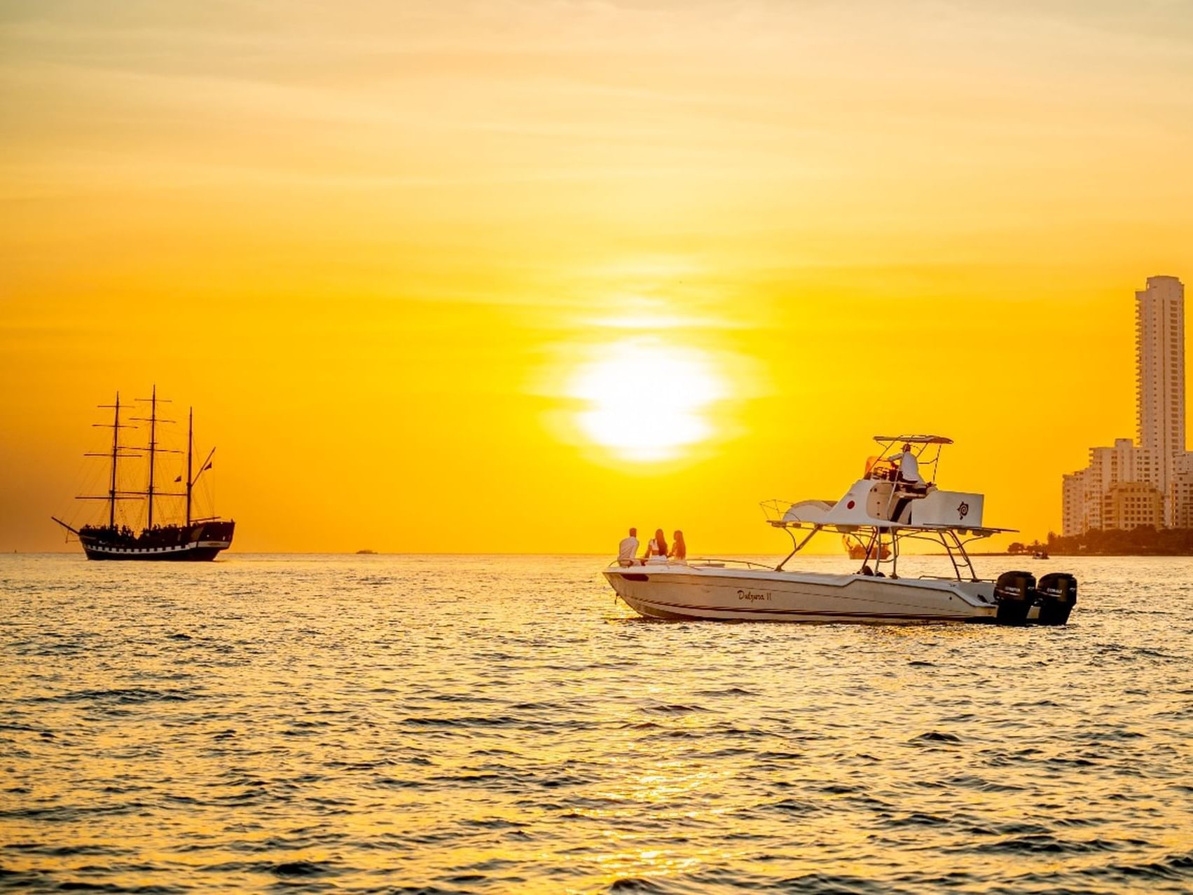 Old ship and Dulzura 2 Boat on the sea during sunset near Hotel Isla Del Encanto