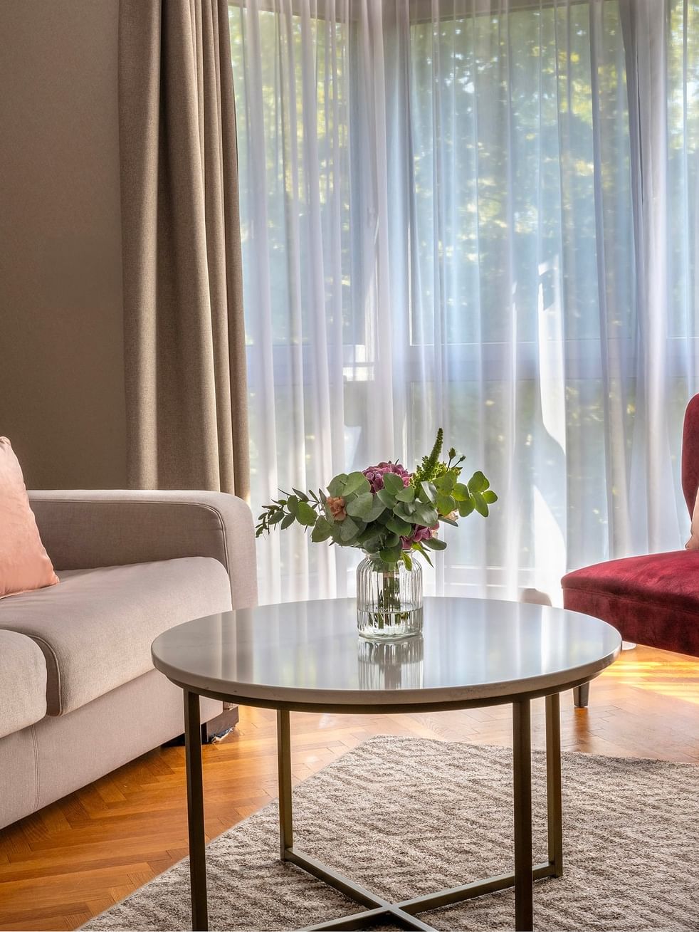 Comfortable living room with couch, chair, and table at Warwick Reine Astrid.