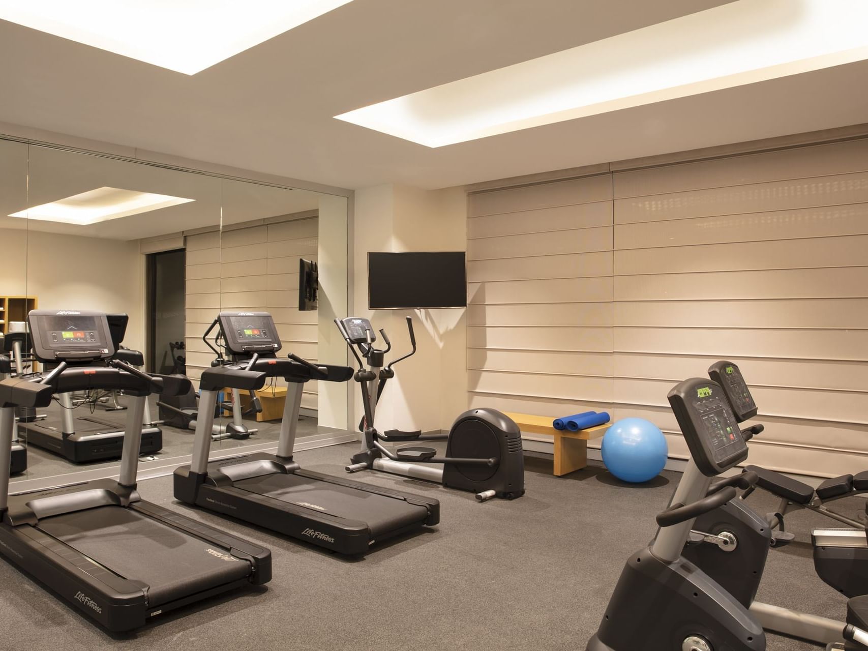 Exercise machines & Tv in a Gym Wellness Center at Fiesta Inn