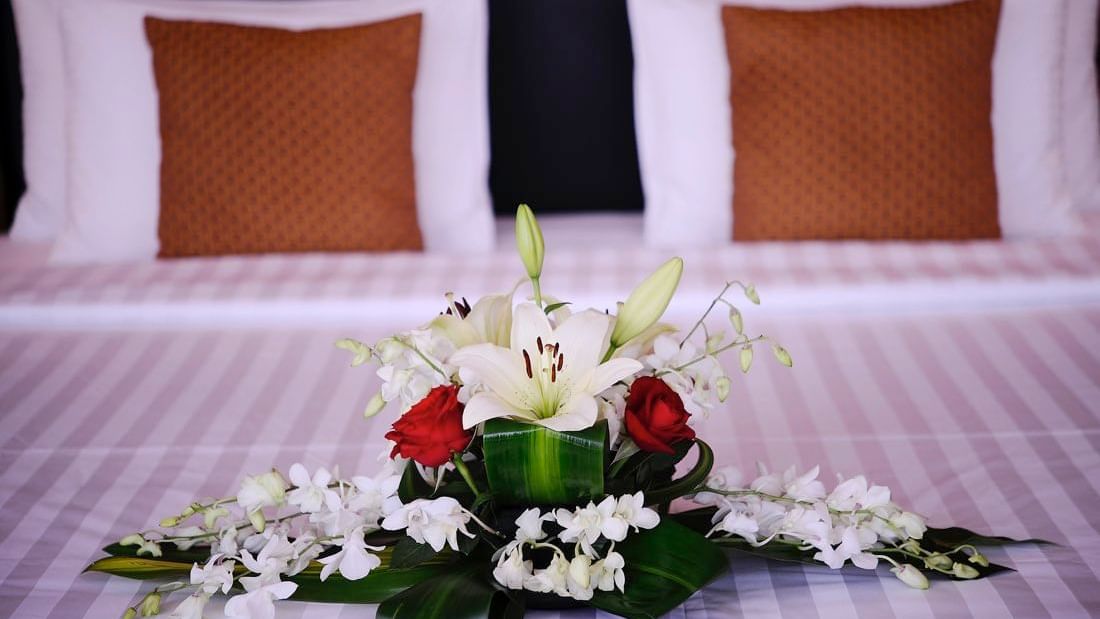Flower décor on the bed in Deluxe Room at Al Hamra Palace by Warwick Riyadhd