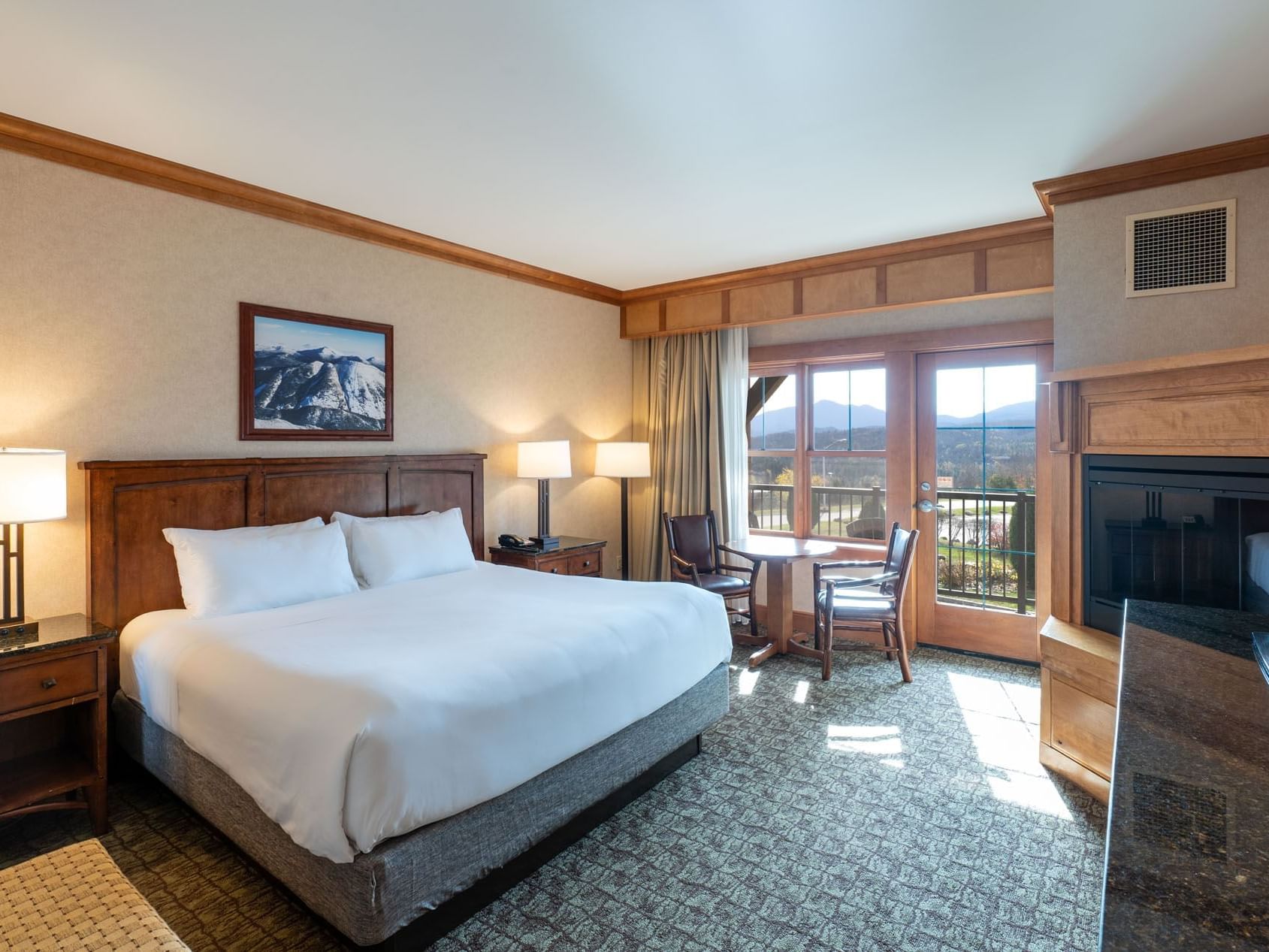 King Room at Lake Placid Club Grandview with a simple table and chairs by sliding glass doors leading to a private balcony