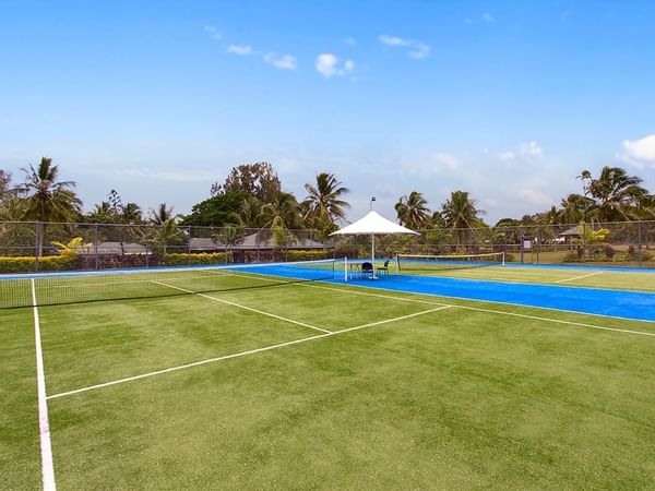 Outdoor tennis court with white lines at Warwick Le Lagon 