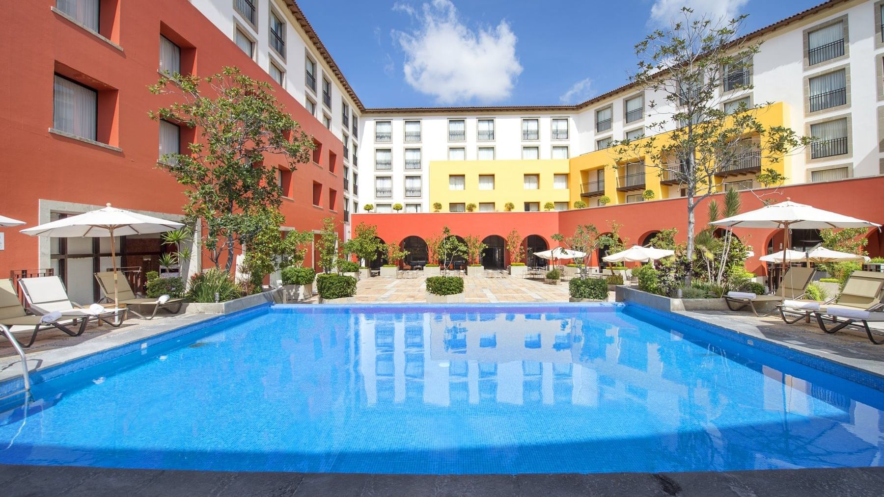 Pool with sunbeds at Grand Fiesta Americana Querétaro