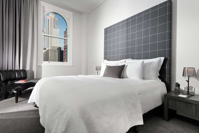 King bed & lounge chair in Heritage Hotel Room at Melbourne Hotel Perth