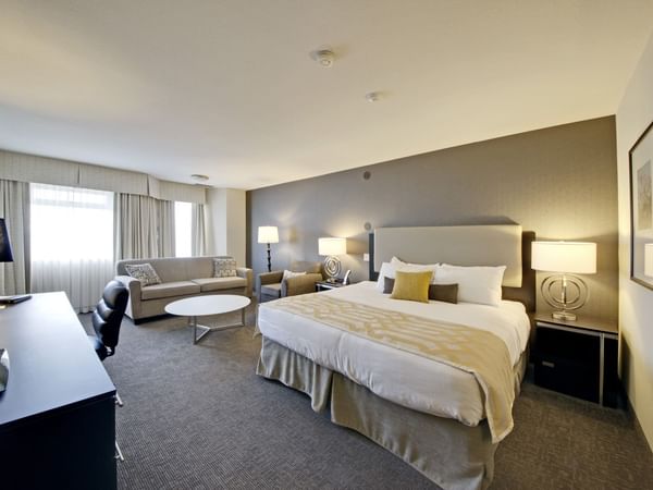 King bed in hotel room with sofa