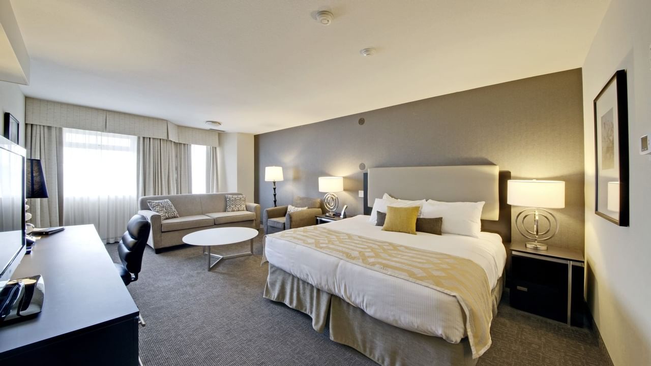 King bed in hotel room with sofa