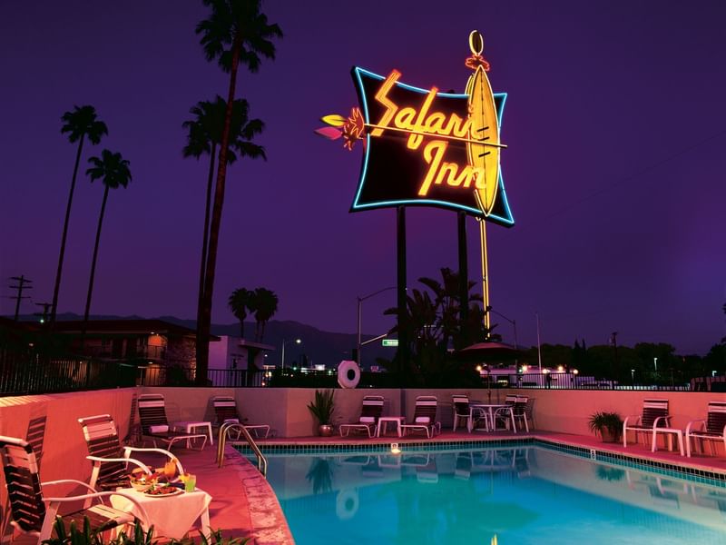 Outdoor pool at Safari Inn, a Coast Hotel at night
