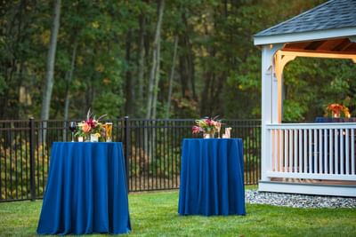 Outdoor high-top cocktail tables showcasing events in Portland Me on the lawn at Sable Oaks Weddings and Events