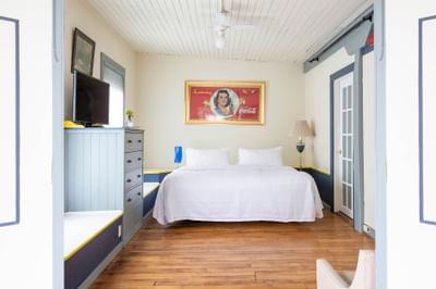 Large bed, TV & nightstand in Apartment 405 at Retro Suites Hotel