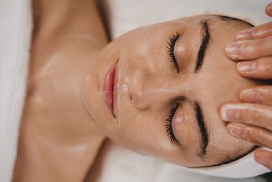 Guest receiving a relaxing facial treatment at the spa at Anchorage By The Sea