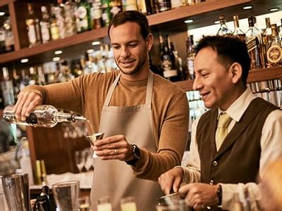 Bartender and waiter preparing a drink at Hotel Sumaq
