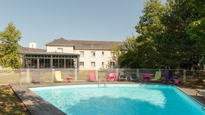 Lounge area by the outdoor swimming pool at Hotel La Saulaie