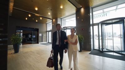 a couple walking into a hotel lobby