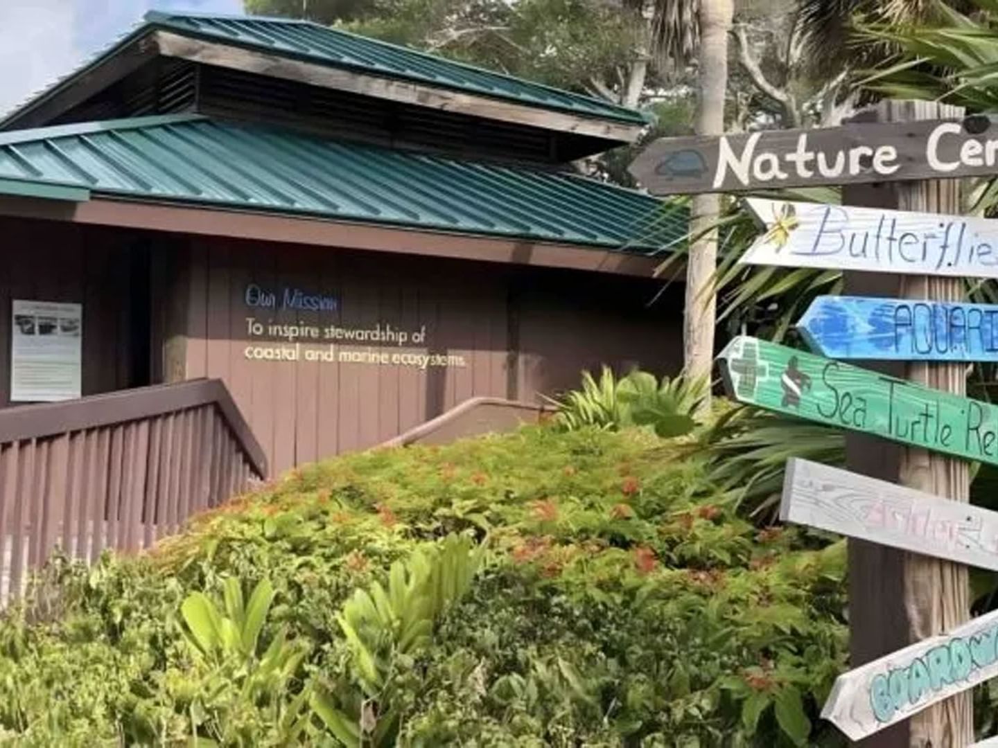 Direction signpost in front of a building in Gumbo Limbo Nature Center near Ocean Lodge Boca Raton