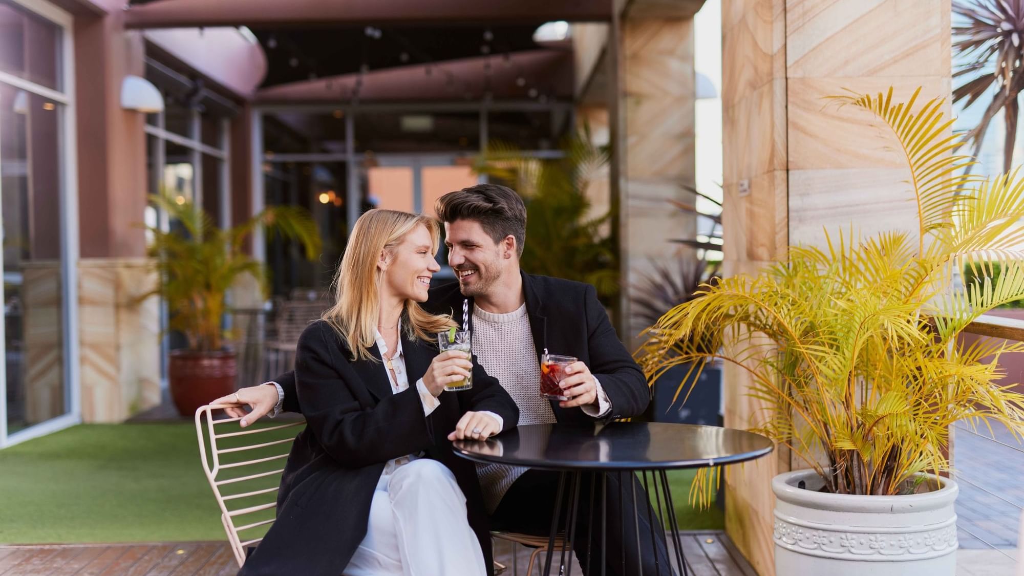 Couple enjoying sunset drinks on ibis bar deck