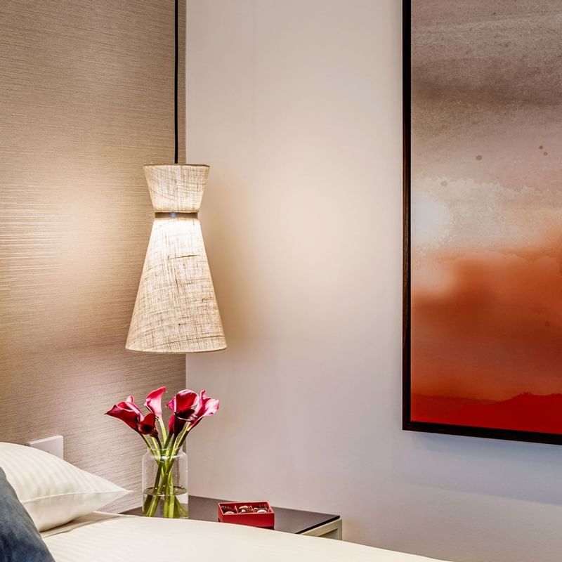 Close-up of a bed & lampshade in a room at Crown Promenade