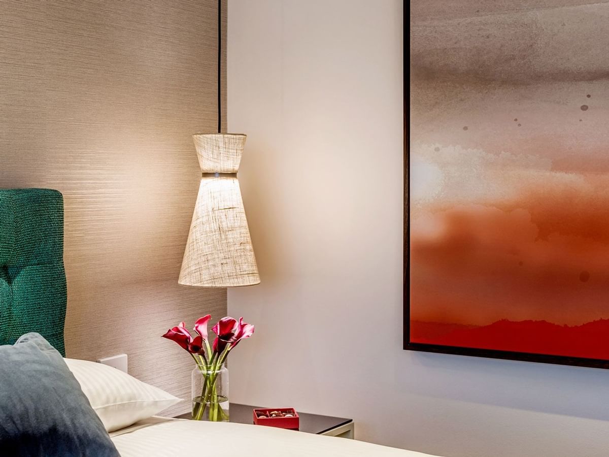 Close-up of a bed & lampshade in a room at Crown Promenade