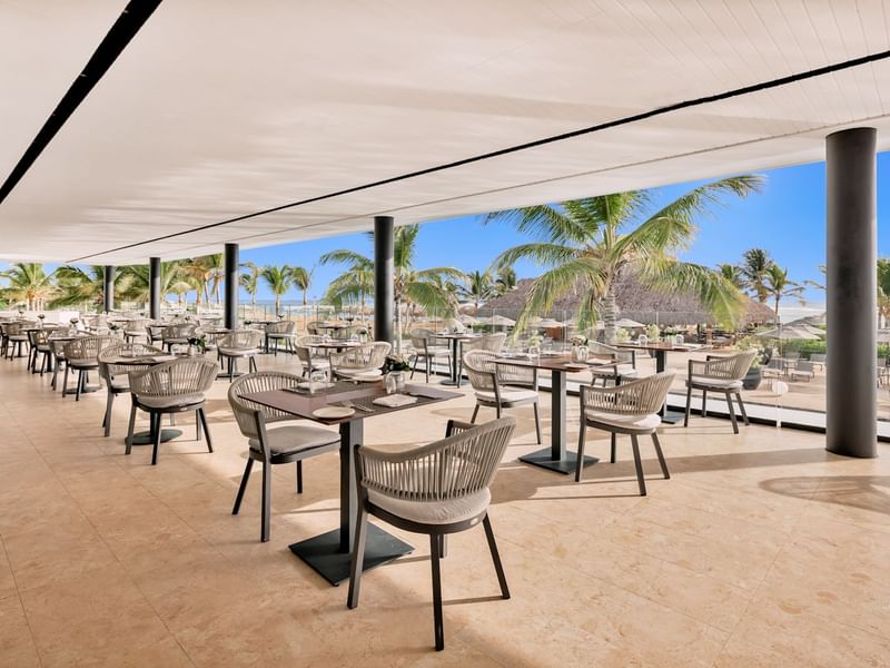 Restaurant-style dining set-up with a view of the beach near Live Aqua Resorts and Residence Club