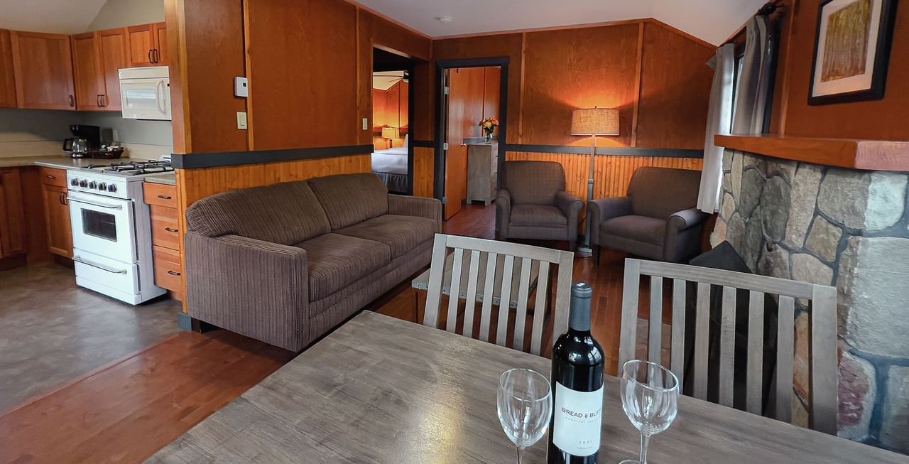 Sitting area, couch, fireplace, kitchen, and bedroom